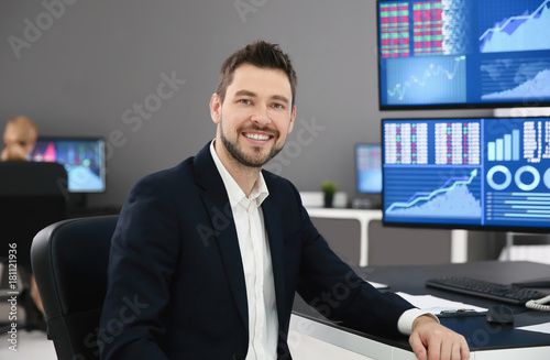 Male stock trader working in office