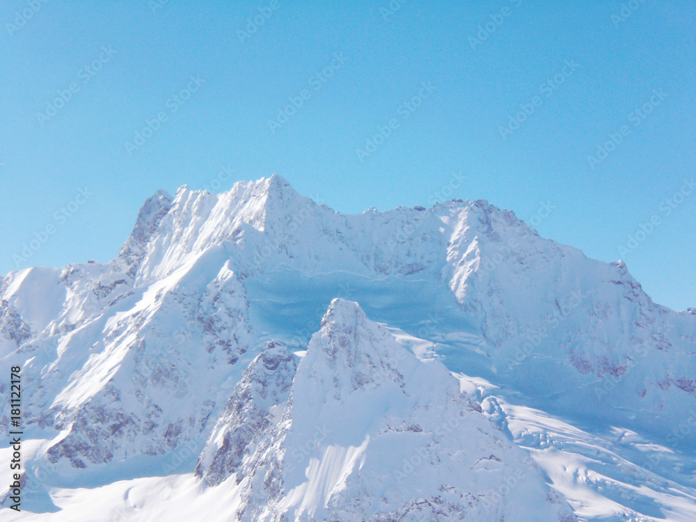 Obraz premium Views of snow capped mountains of Dombay. Winter Sunny day, the Caucasus mountain range, avalanche
