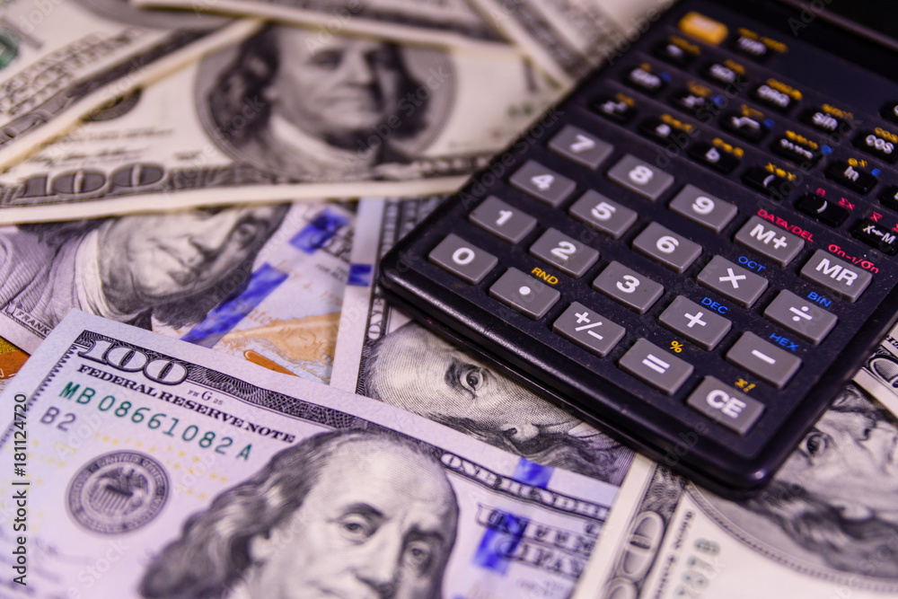 Modern calculator on a one hundred dollar bills Modern calculator on a one hundred dollar bills
