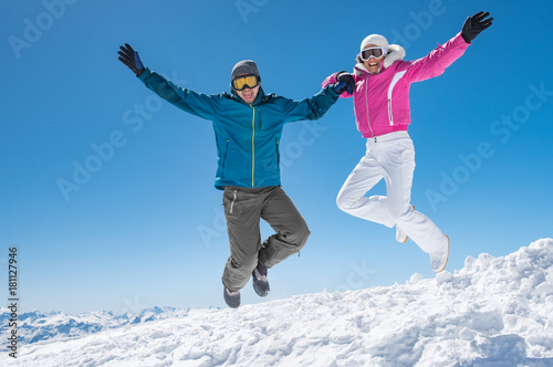 Couple jumping on snow