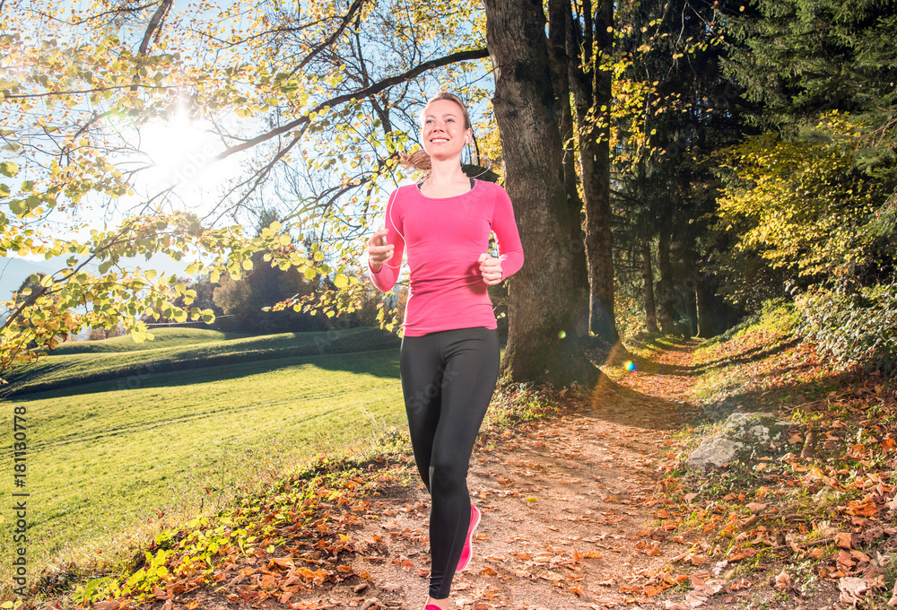 Young, sexy woman runs through a colorful autumn forest in the mountains - she is doing her running workout outdoor at a beautiful sundown and a amazing landscape Young, sexy woman runs through a colorful autumn forest in the mountains - she is doing her running workout outdoor at a beautiful sundown and a amazing landscape