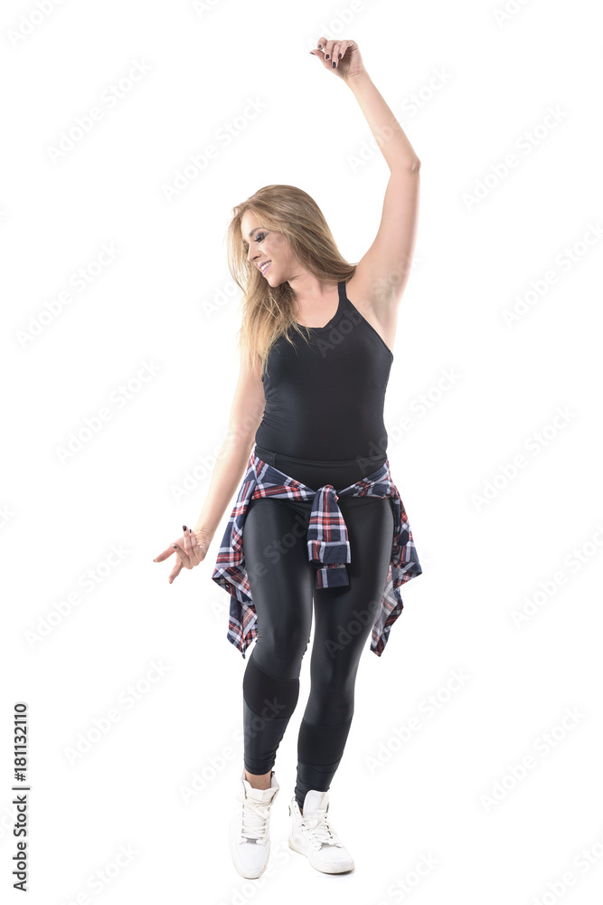 Smiling young attractive jazz dance dancer moving with raised arm looking down. Full body length portrait isolated on white background.