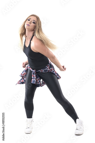 Jazz dance aerobics instructor dancing and moving bent forward. Full body length portrait isolated on white studio background. 