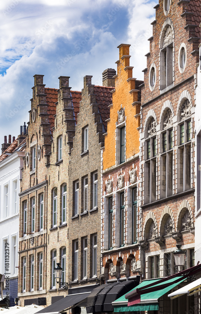 Typical Belgian street with colorful buildings. Few traditional brick buildings with tiled roofs in a row