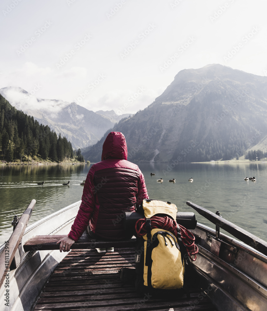 Austria, Tyrol, Alps, woman in boat on mountain lake