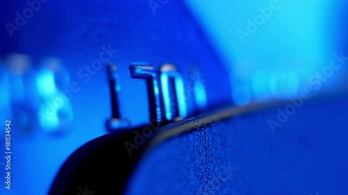 Payment by the credit card. Сredit card in the payment terminal, extreme closeup.
