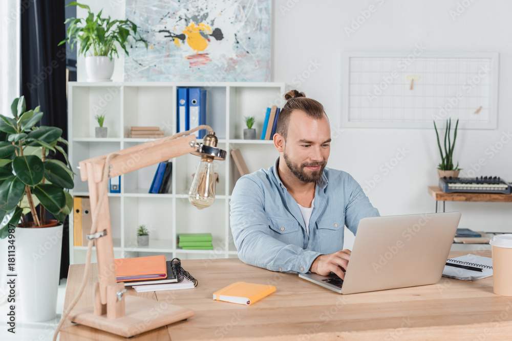 young man working with laptop