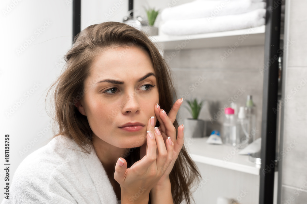 Woman checking face skin Woman checking face skin