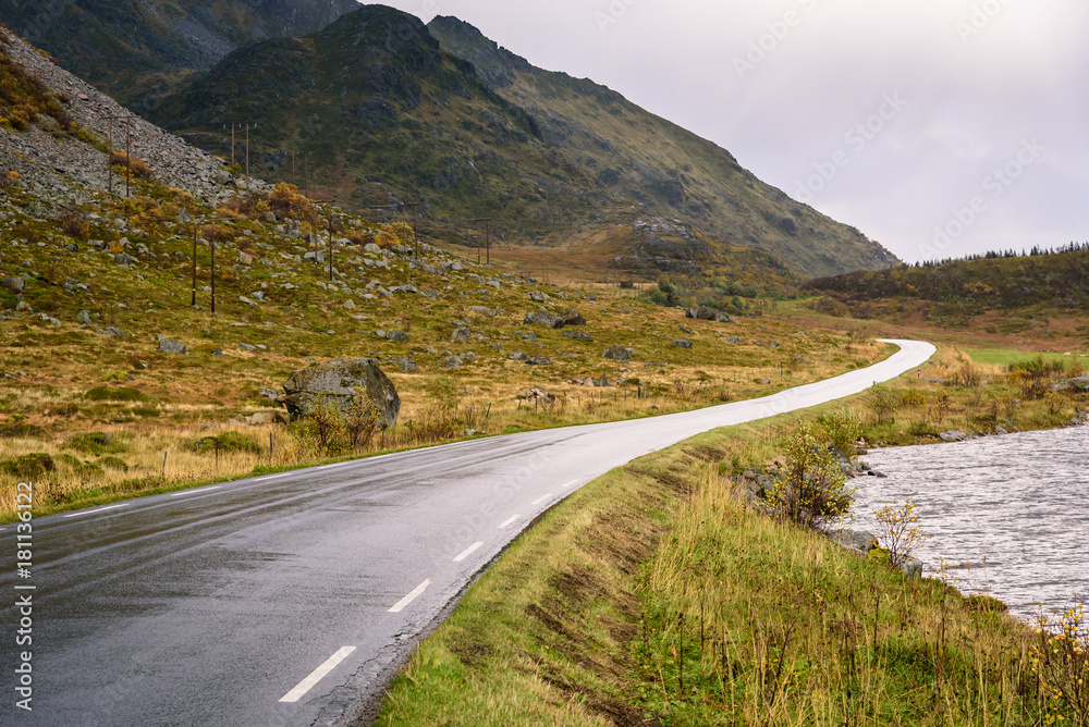Fototapeta premium Asphalt curved road along mountain, Lofoten, Norway