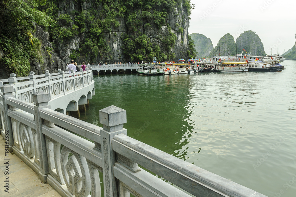 dock for tourists' ships in Halong Bay and from its islands to the evening in Vietnam.