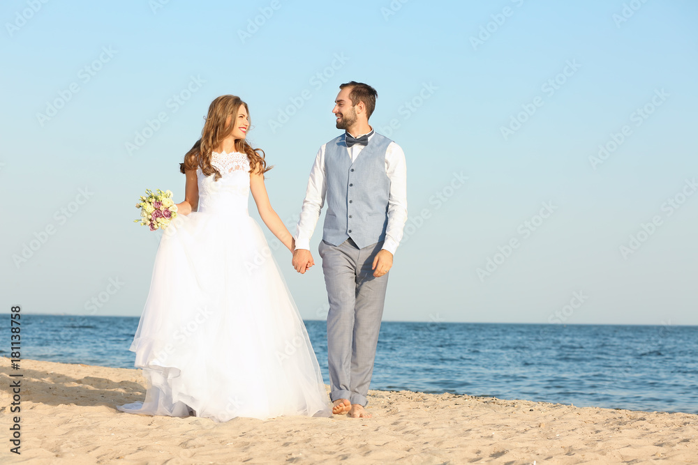 Happy wedding couple on sea beach Happy wedding couple on sea beach