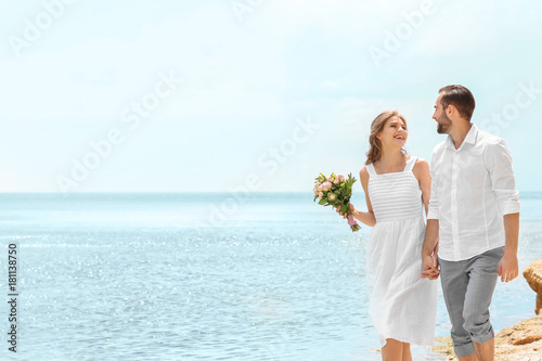 Happy newlywed couple walki...