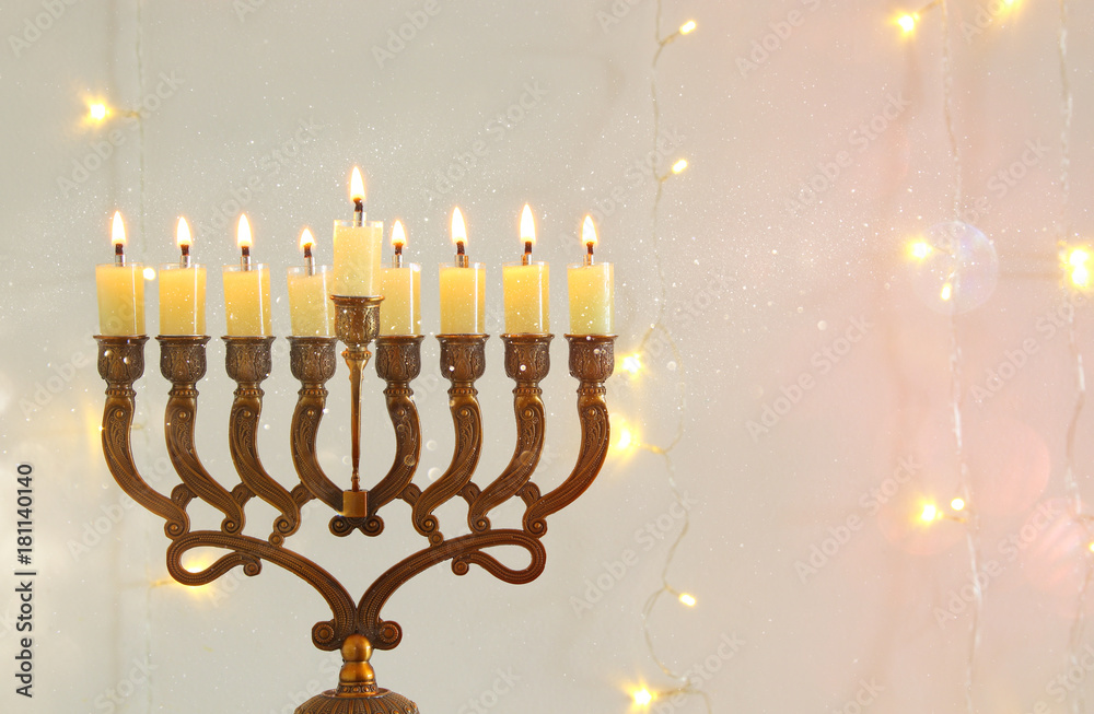 Fototapeta premium image of jewish holiday Hanukkah background with menorah (traditional candelabra)
