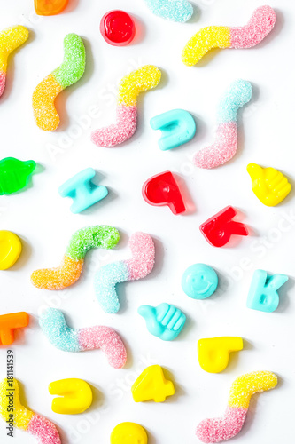 Delicious sugar lollipops on white background top view pattern