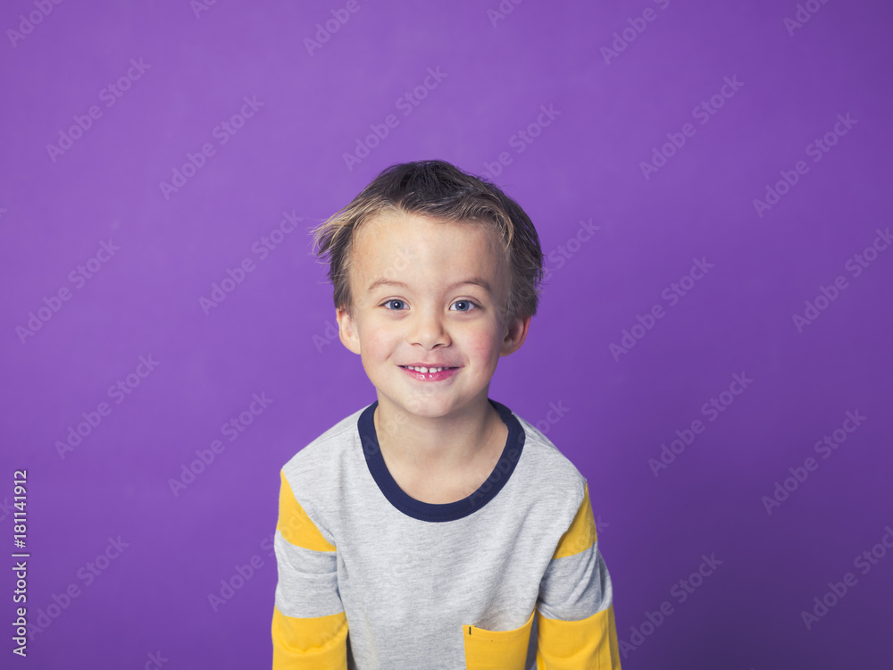 5 year old boy portrait in front of violet background 5 year old boy portrait in front of violet background