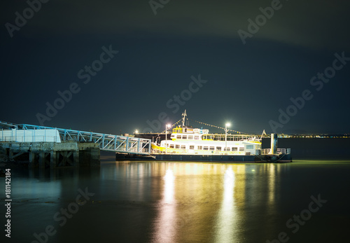 Moored ship at the pier at night.