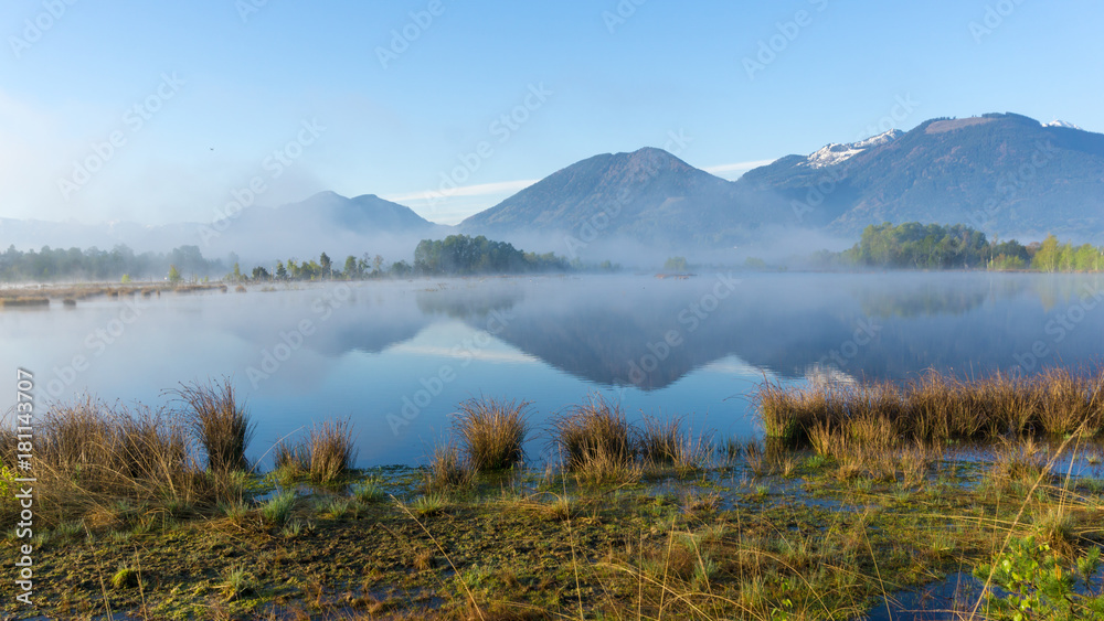 Epic landscape photo with morning fog in a moorland area in the mountains of the Bavarian Alps Epic landscape photo with morning fog in a moorland area in the mountains of the Bavarian Alps