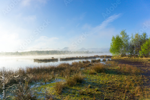 Epic landscape photo with morning fog in a moorland area in the mountains of the Bavarian Alps