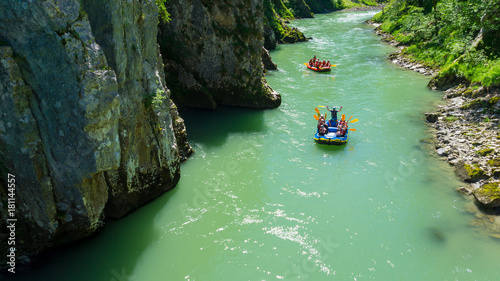 Adventure rafting in a canyon on a river in the alps on a sunny day