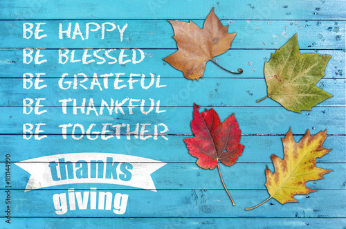 Thanksg giving greeting poster card with four leaf on blue wooden table photo