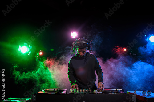 DJ in headphones with sound mixer