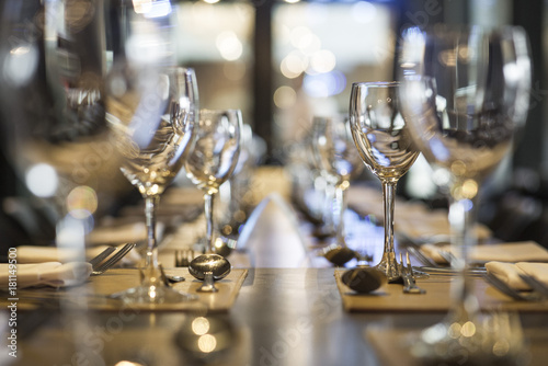 Wineglasses arranged on dining table photo