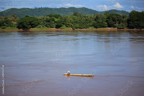 Fisherman cacth fish on the wooden boath in Mekong river, Thailand photo