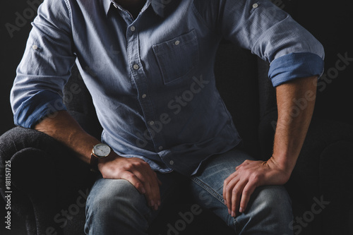 man sitting in armchair
