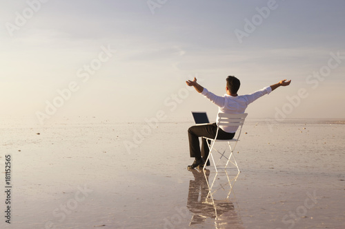 Wallpaper Mural Business man with laptop working on the beach Torontodigital.ca
