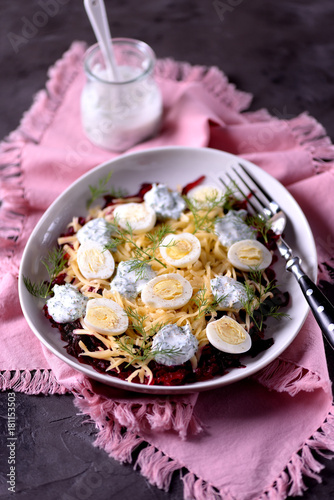 Bild auf Leinwand Healthy salad from boiled beetroot, hard cheese, quail eggs and dressings from natural yogurt with dill, black pepper and sea salt