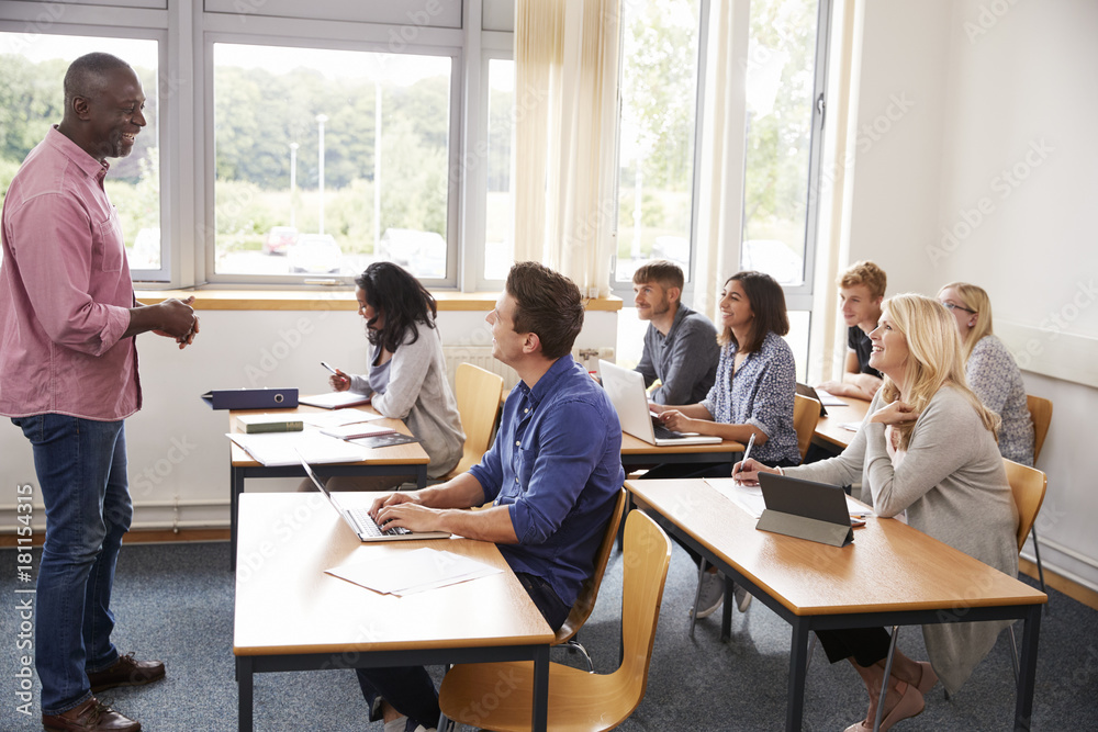 Male Tutor Teaching Class Of Mature Students