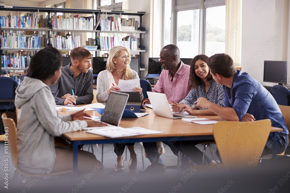 Group Of Mature College Students Collaborating On Project Group Of Mature College Students Collaborating On Project