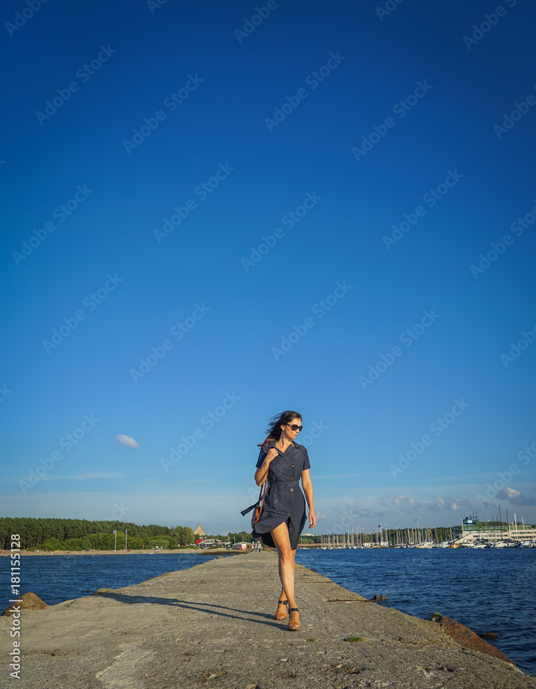 Beautiful woman walking near baltic sea