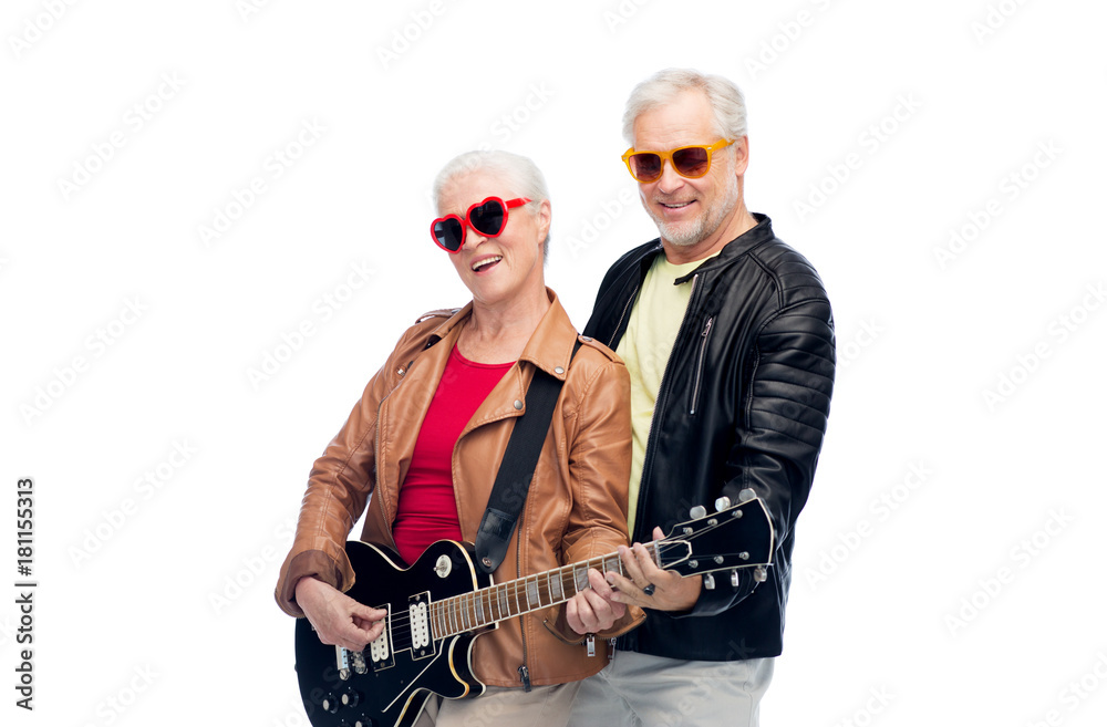 Naklejka premium senior couple in sunglasses with electric guitar