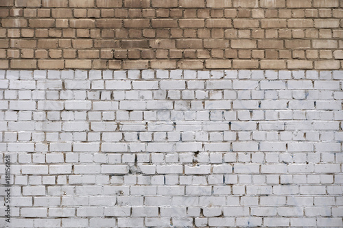 The wall is made of bricks. It is painted white. Not a painted brick. Background. Exterior