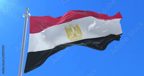 Flag of Egypt waving at wind with blue sky in slow, loop photo
