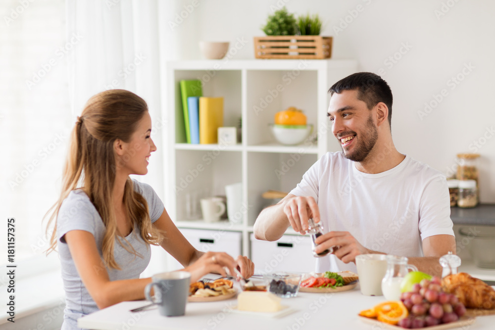 happy couple having breakfast at home