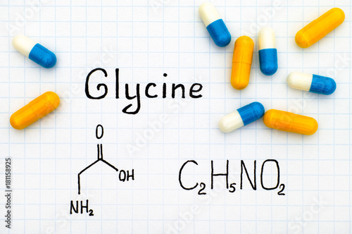 Chemical formula of Glycine with some pills. photo