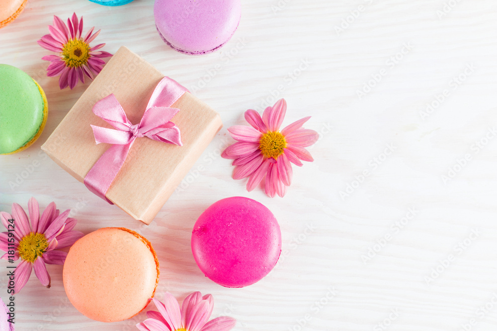 Photo of cake macarons, gift box, tea, coffee, cappuccino and flowers. Sweet romantic food macaroon concept. Morning breakfast and presents. Photo of cake macarons, gift box, tea, coffee, cappuccino and flowers. Sweet romantic food macaroon concept. Morning breakfast and presents.