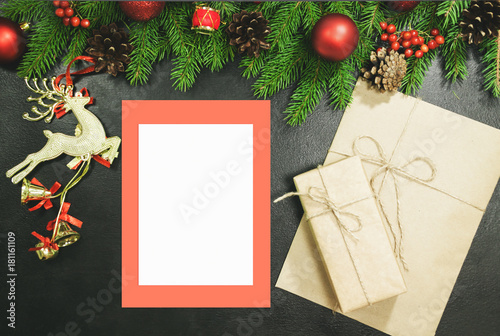 Christmas background or Xmas card  with decorations fir, gift box and ornamen. Space for Holiday Greetings.  Top view. Planning of New Year's holidays