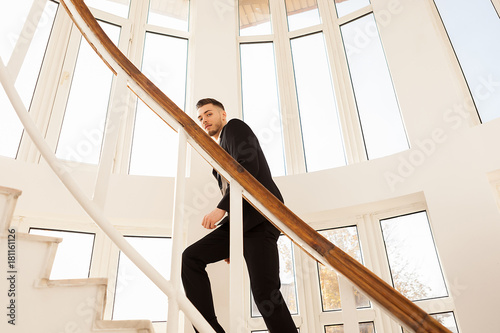 Business man in formal suit walking on the stairs of an office building