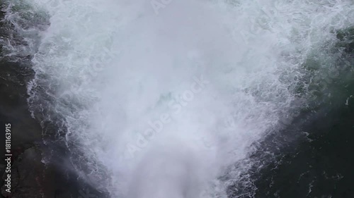 Vista cenital de enorme chorro de agua saliendo  en el punto de evacuacion de una presa o dique de embalse 
 photo