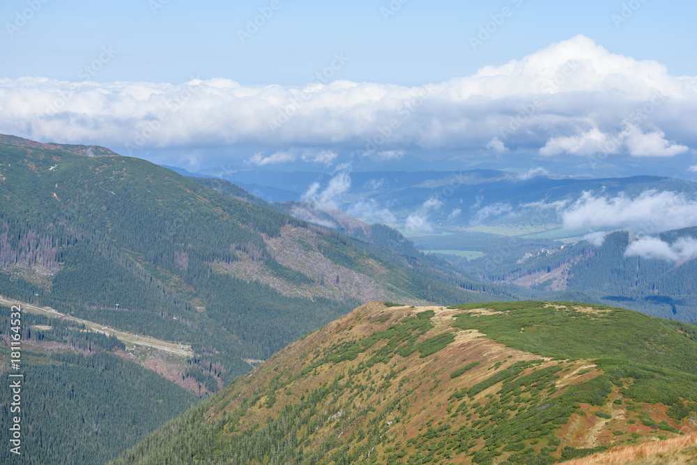 mountain tops in autumn covered in mist or clouds mountain tops in autumn covered in mist or clouds