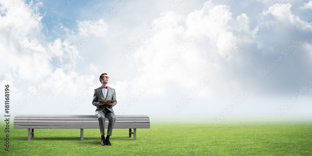 Young businessman or student studying the science in summer park Young businessman or student studying the science in summer park