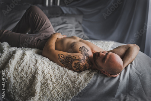 Portrait of the hunky men resting on the bed 21. photo
