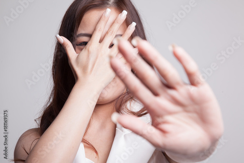 Young Asian woman hide her  face.