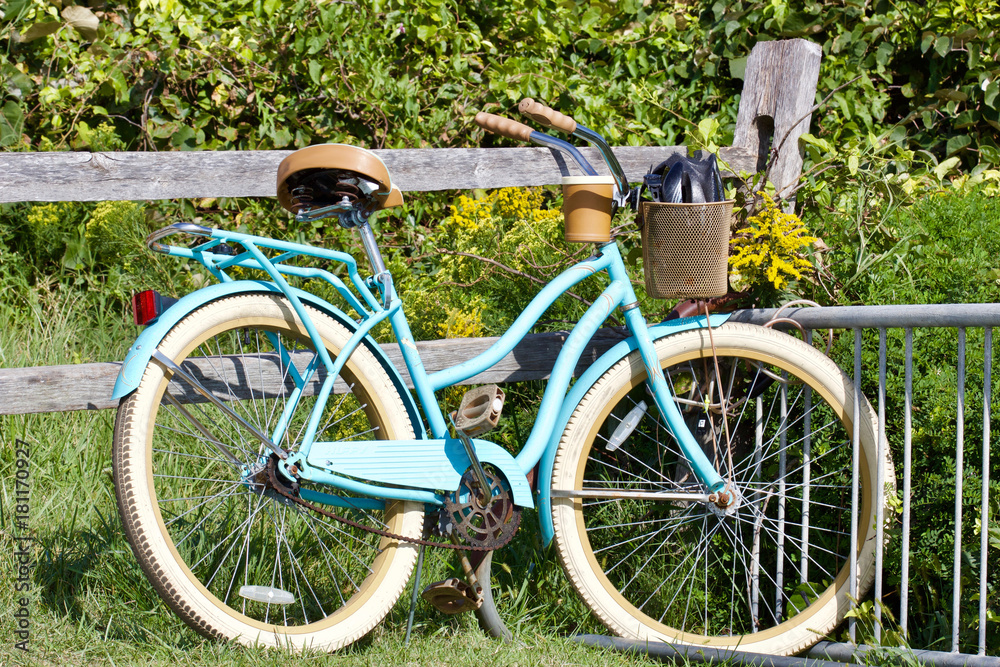 Vintage bicycle against rustic fence
