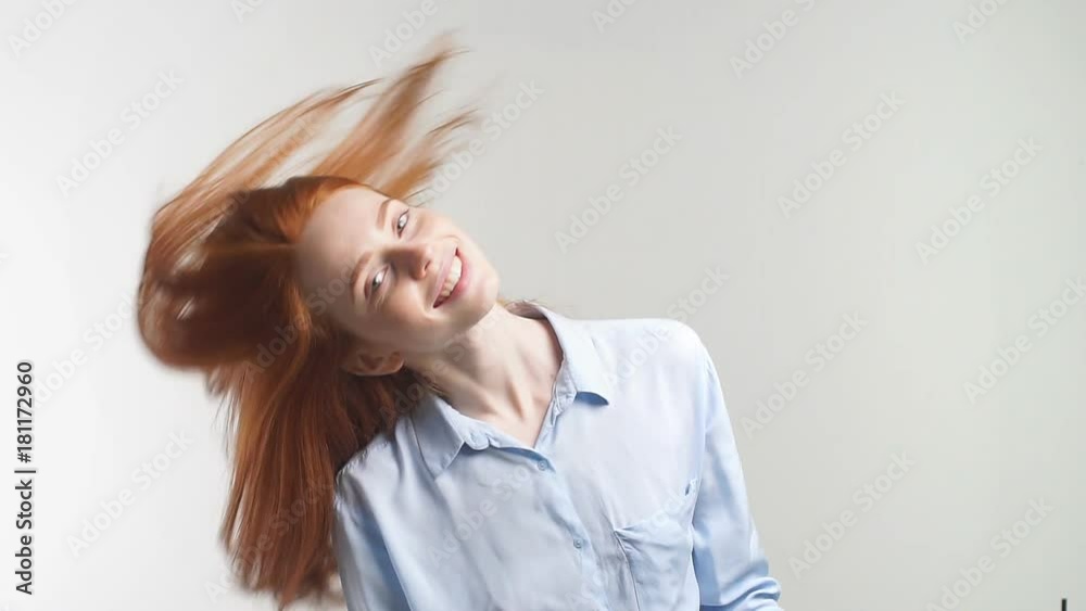 Happy attractive girl with curly red hair smiling looking at camera. Slow motion. Happy attractive girl with curly red hair smiling looking at camera. Slow motion.