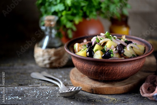 Salad from boiled potatoes, red onions, dried olives, parsley with olive oil, sea salt and wine vinegar.
