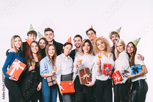 Corporate, celebration and holidays concept - happy team with gifts having fun birthday party.